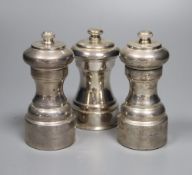 Three assorted modern silver mounted pepper mills, including a pair, London, 1980, tallest 10.5cm.