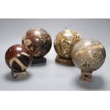 Four marble balls on stands