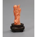 A Chinese coral figure of Shou Lao, on stand, height 8cm