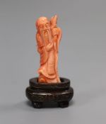 A Chinese coral figure of Shou Lao, on stand, height 8cm