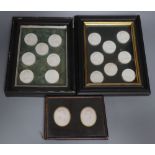 A collection of intaglio relief portrait plaques in a tray and a pair of framed sets