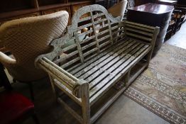 A Lutyens-style weathered teak garden bench, width 170cm height 106cm