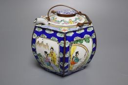 A polychrome-enamelled ceramic wine pot and cover with hexagonal outer case decorated figures in