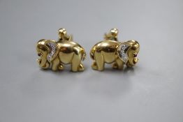 A pair of modern' yellow metal (stamped 750), diamond and cabochon ruby set elephant cufflinks,