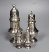 Four assorted 20th century silver casters, including a small pair, tallest 19.3cm, 11.5oz.