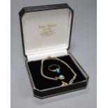 A cabochon turquoise-set oval pendant on 9ct gold fine chain and a similarly-set 9ct gold ring,