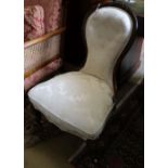 A Victorian carved walnut nursing chair