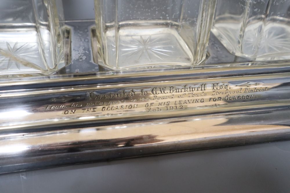 A silver plate three bottle tantalus, width 38cmCONDITION: Two decanters each with a chip to the - Image 2 of 2