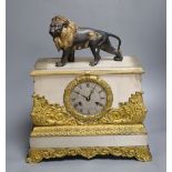 A French gilt and silvered mantel clock, with associated lion surmount, height 40cm