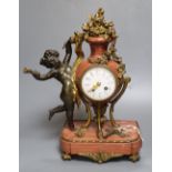 A 19th century French ormolu mounted rouge marble mantel clock, cast with putti, height 36cm