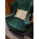 A George III style walnut upholstered wing armchair