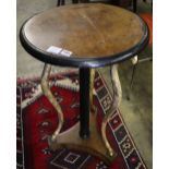 A Regency gilt and ebonised circular walnut occasional table, on triple ram's head support, diameter