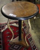 A Regency gilt and ebonised circular walnut occasional table, on triple ram's head support, diameter