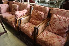 An early 20th century carved mahogany three piece bergere suite