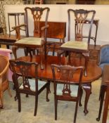 An early 20th century Chippendale revival mahogany dining suite comprising extending dining table