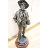 After H. Wiesse. A large patinated spelter figure of a fruit picker entitled "Siffleur" signed,