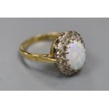 A modern 18ct gold, white opal and diamond set oval cluster ring, size J, gross 4.4 grams.CONDITION: