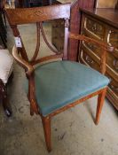 An early 19th century Dutch floral marquetry inlaid elbow chair