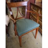 An early 19th century Dutch floral marquetry inlaid elbow chair