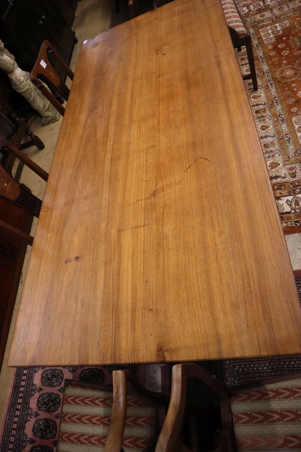 A Gordon Russell walnut dining table, circa 1930, on chamfered double end supports and central - Image 2 of 3