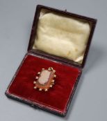 A yellow metal and sardonyx cameo hardstone and seed pearl set pendant brooch, carved with the