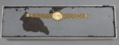 A lady's 1990's 18ct gold Omega quartz wrist watch on Omega 18ct gold bracelet, overall length 15.