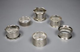 Six assorted silver napkin rings.