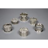 Six assorted silver napkin rings.