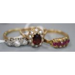 Two 18ct and gem set rings including a three stone diamond ring and a ruby and diamond ring, gross