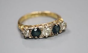 An early 20th century 18ct gold three stone diamond and two stone sapphire set half hoop ring,