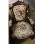 A late Victorian carved walnut upholstered open armchair