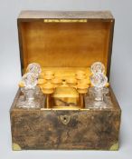 A Victorian pressed glass decanter part set, four decanters and four tots, within fitted brass