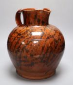 A 19th century Sussex terracotta jug, with black striped glaze, height 30cm (a.f.)CONDITION: Piece