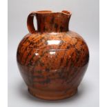 A 19th century Sussex terracotta jug, with black striped glaze, height 30cm (a.f.)CONDITION: Piece