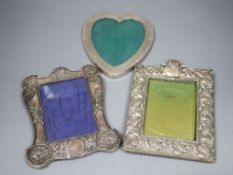 Two early 20th century repousse silver mounted photograph frames(a.f.) and a sterling heart shaped