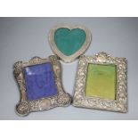 Two early 20th century repousse silver mounted photograph frames(a.f.) and a sterling heart shaped