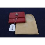 A Hermes, Paris red leather purse and cloth cover