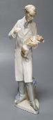 A Lladro figure, vet treating dog, 34cm