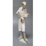 A Lladro figure, vet treating dog, 34cm