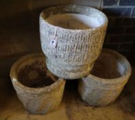 Three reconstituted stone circular garden planters, largest 35cm diameter