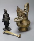 A Himalayan Buddhist brass lamp/ewer with related ladle, 26cm, 19th/20th century and a carved