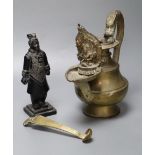 A Himalayan Buddhist brass lamp/ewer with related ladle, 26cm, 19th/20th century and a carved