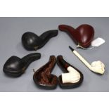 Four cased Meerschaum pipes and another unboxed