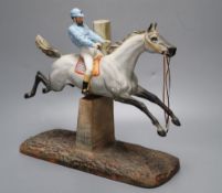 A cast coloured bisque porcelain horse and jockey group, height 26cmCONDITION: Horse tail appears to