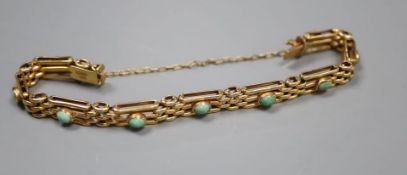 An Edwardian 9ct and nine stone turquoise set gatelink bracelet, approx. 17.5cm, gross 12.1 grams (