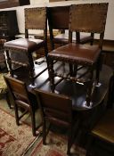 A 1930's oak extending dining table 234cm extended (two spare leaves) and seven dining chairs (one