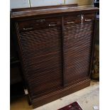 A walnut double tambour filing cabinet, circa 1935, fitted sliding trays, width 90cm, depth 42cm,