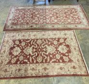 A near pair of Ziegler style red ground rugs, larger 255 x 125cm