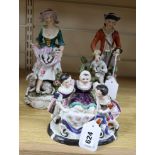 A pair of Meissen style figures of a shepherd and shepherdess and a figural group, tallest 26cm