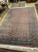 A Bokhara red ground small carpet, a pink ground runner and two other rugs (4), largest 320 x 222cm